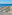 a group of lounge chairs and umbrellas on a beach