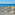 a group of lounge chairs and umbrellas on a beach