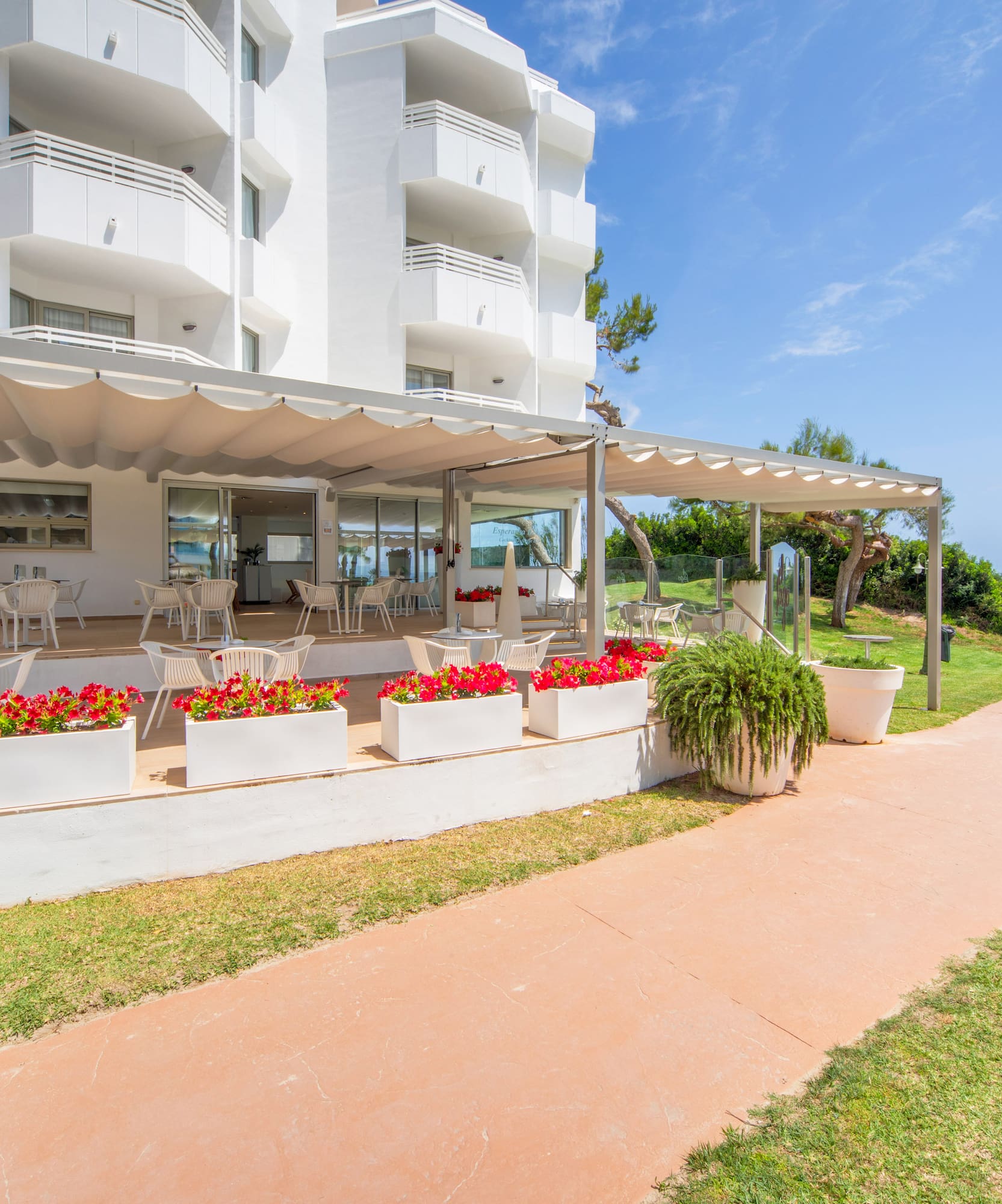 a white building with a patio and a walkway