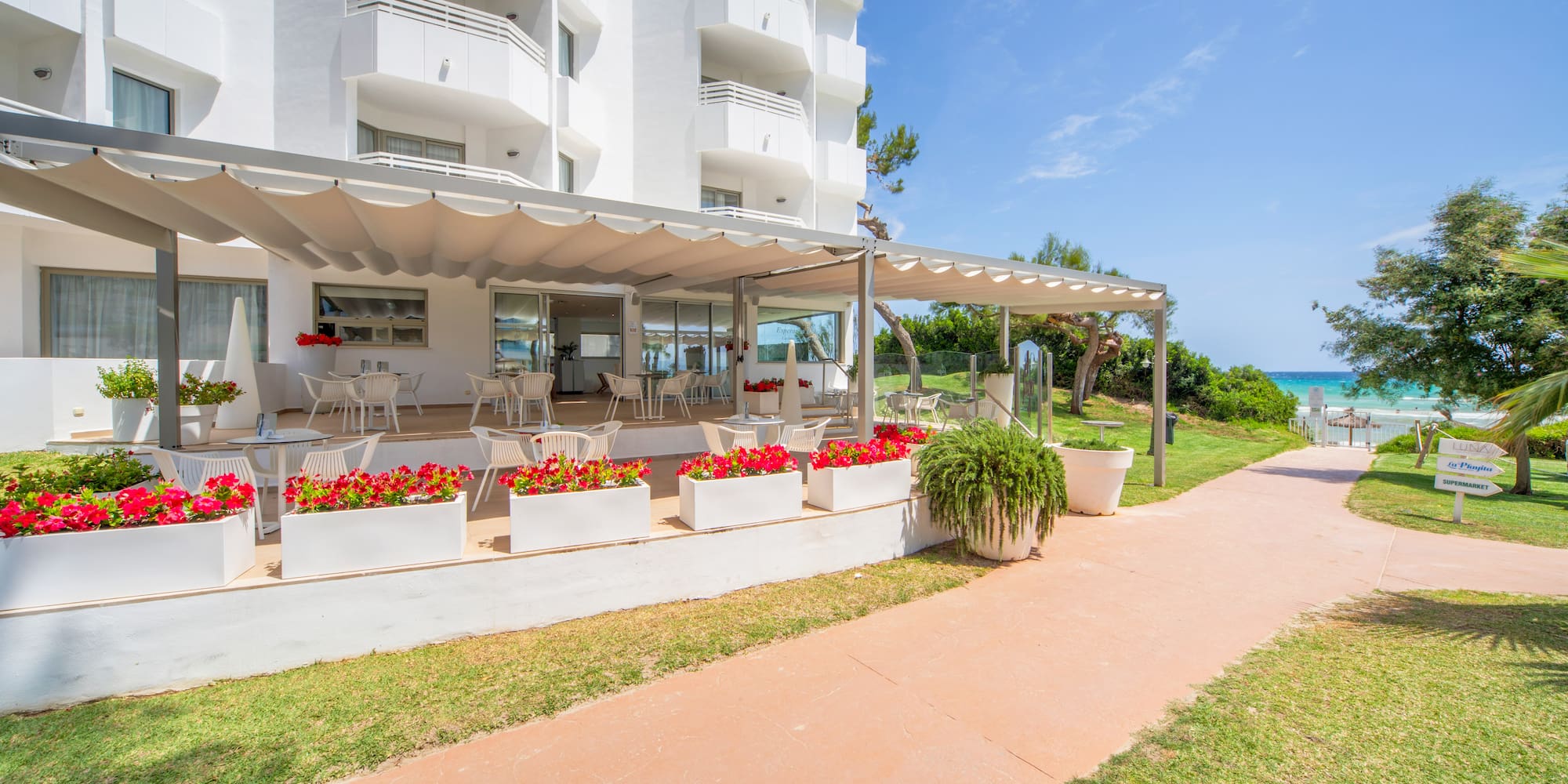 a white building with a patio and a walkway