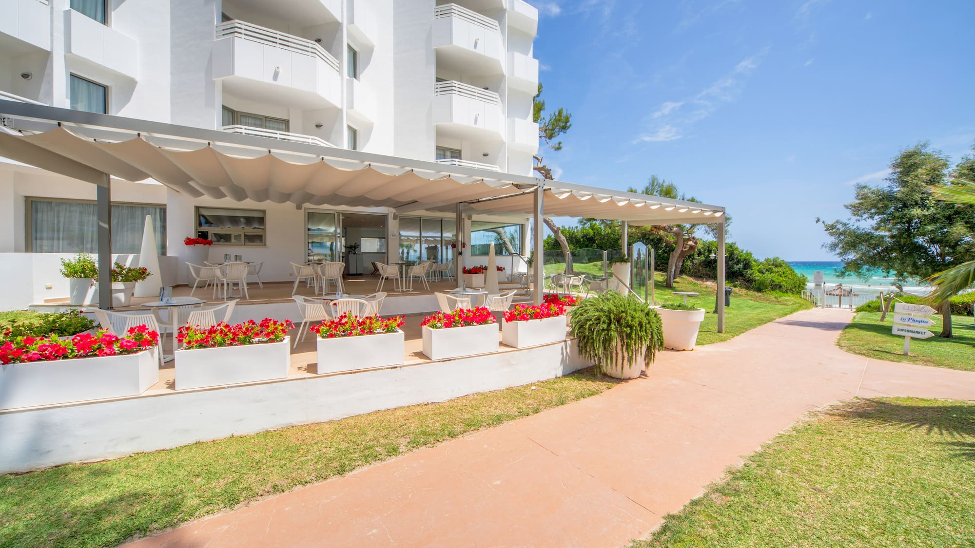 a white building with a patio and a walkway