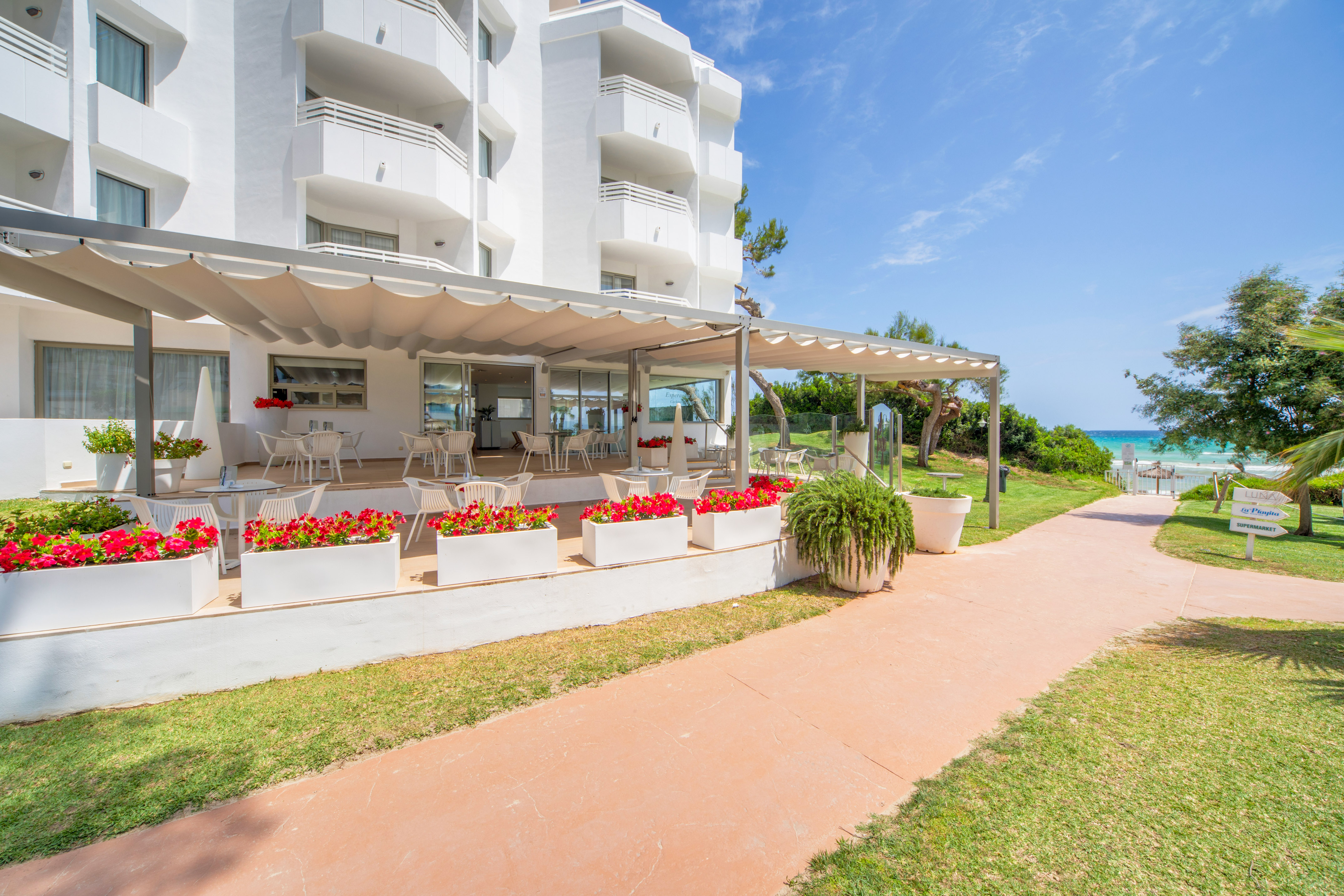 a white building with a patio and a walkway