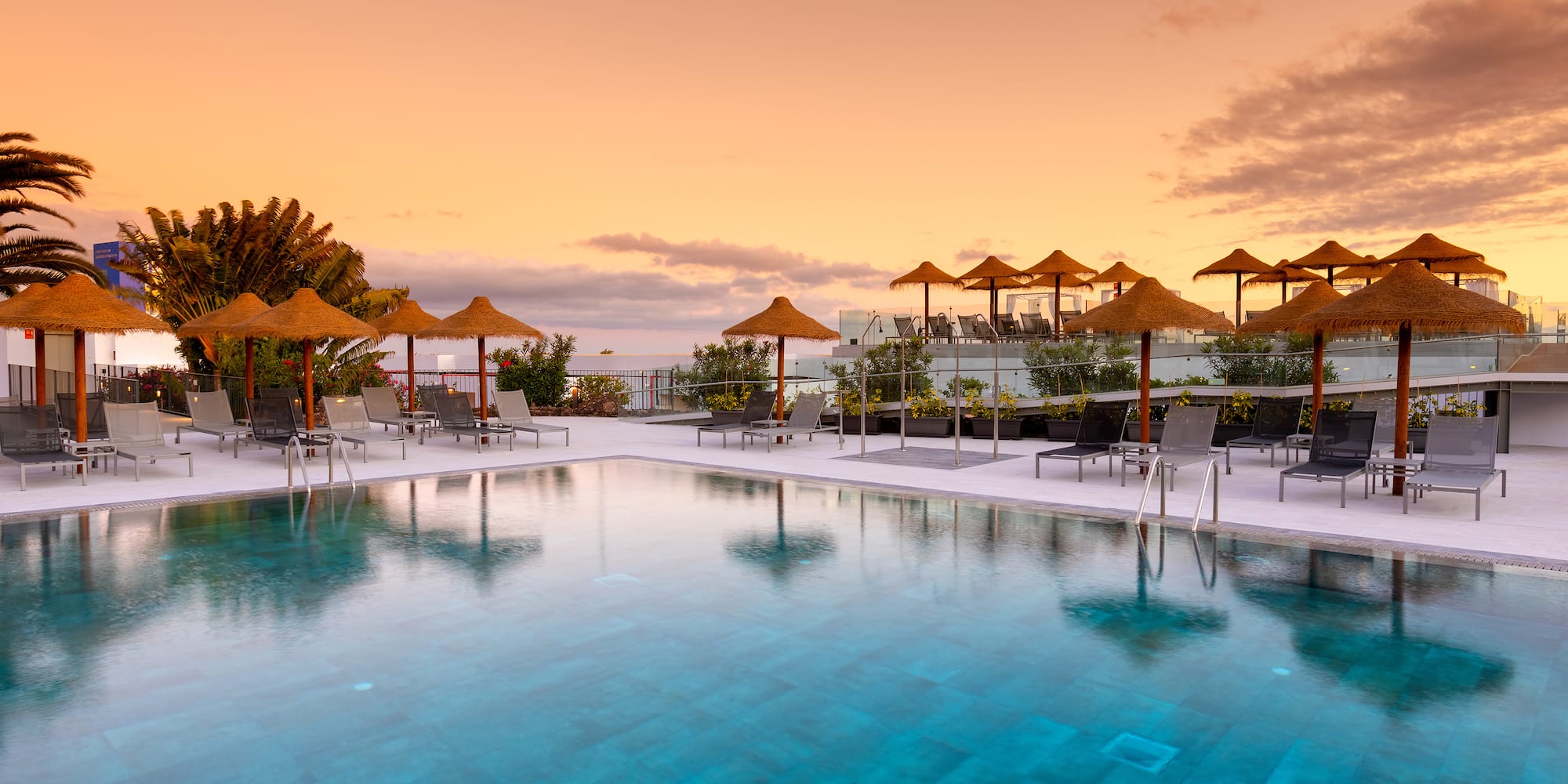 a pool with umbrellas and chairs