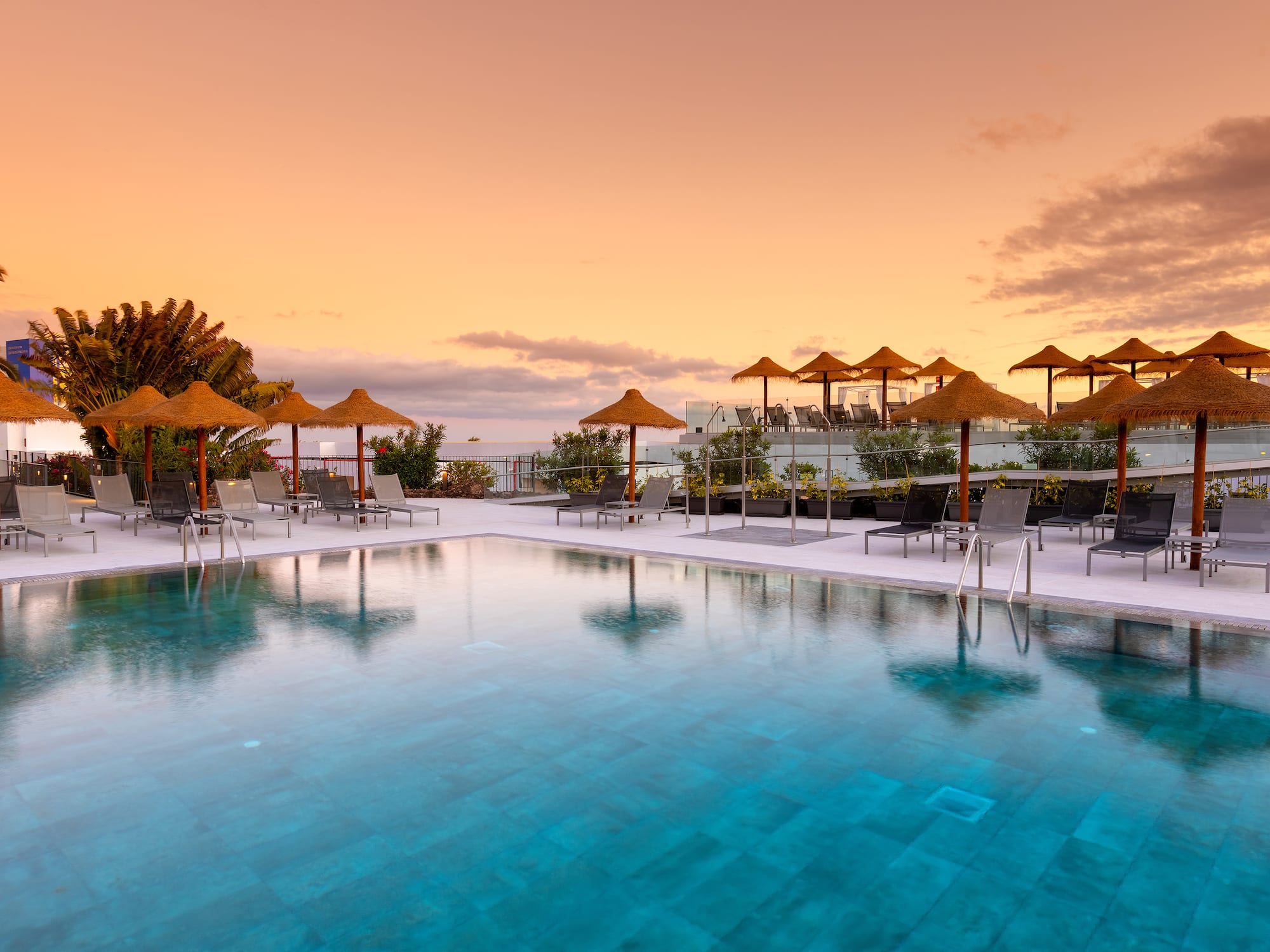 a pool with umbrellas and chairs