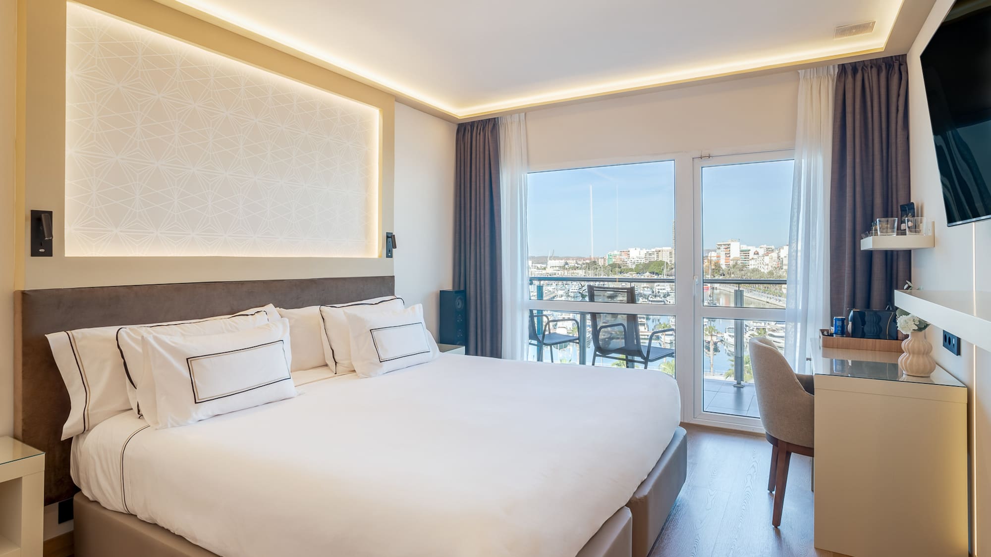 a bedroom with a large bed and a desk