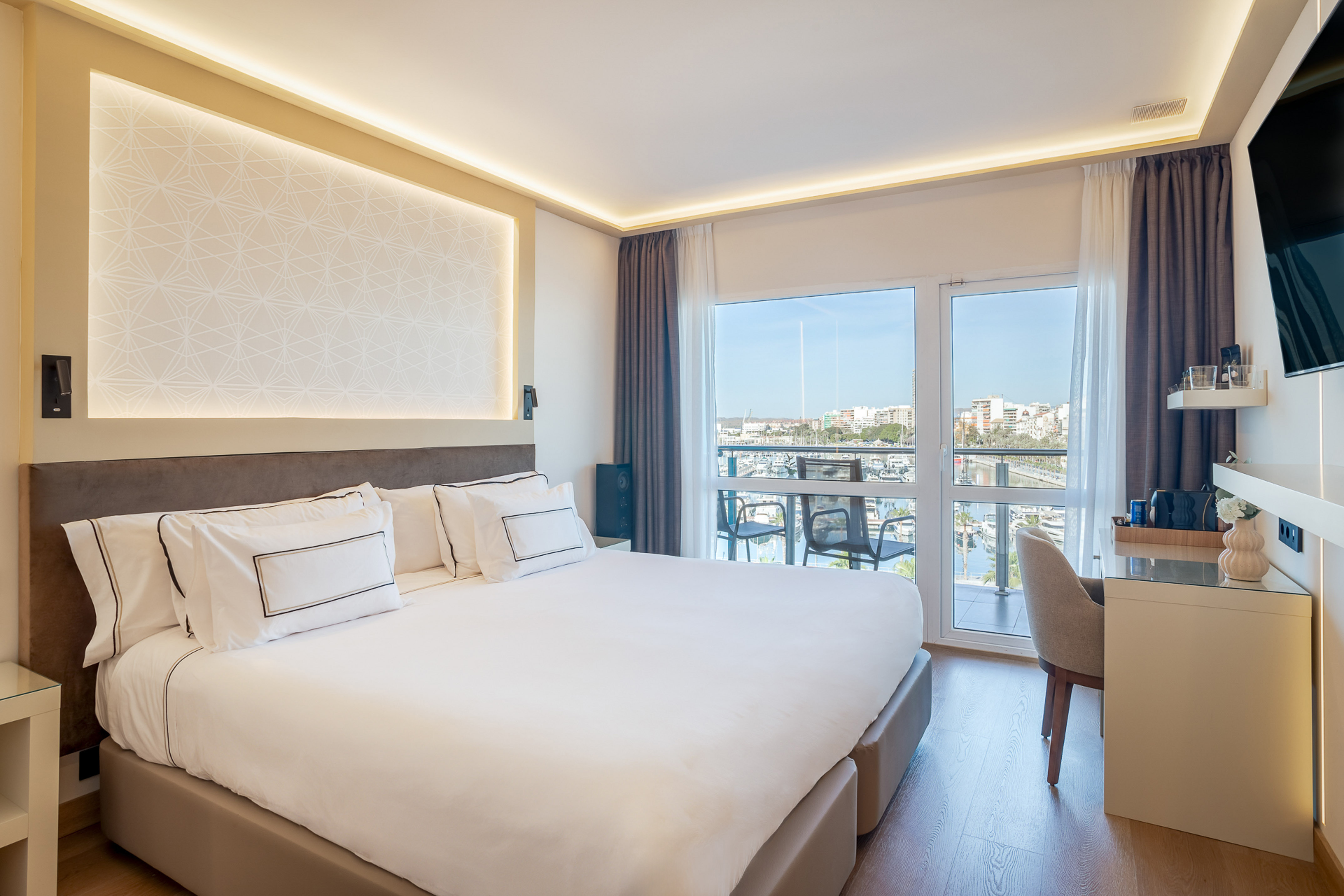 a bedroom with a large bed and a desk
