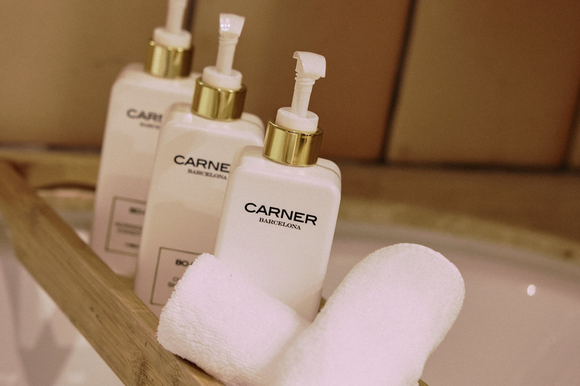 a group of white bottles and towels on a wooden shelf