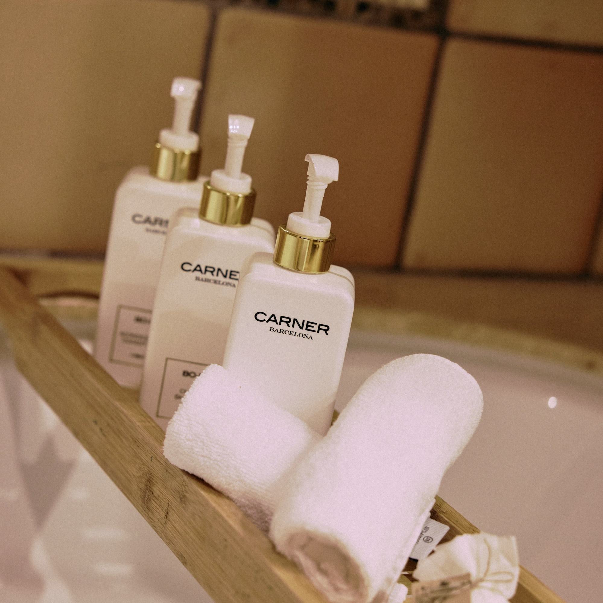 a group of white bottles and towels on a wooden shelf