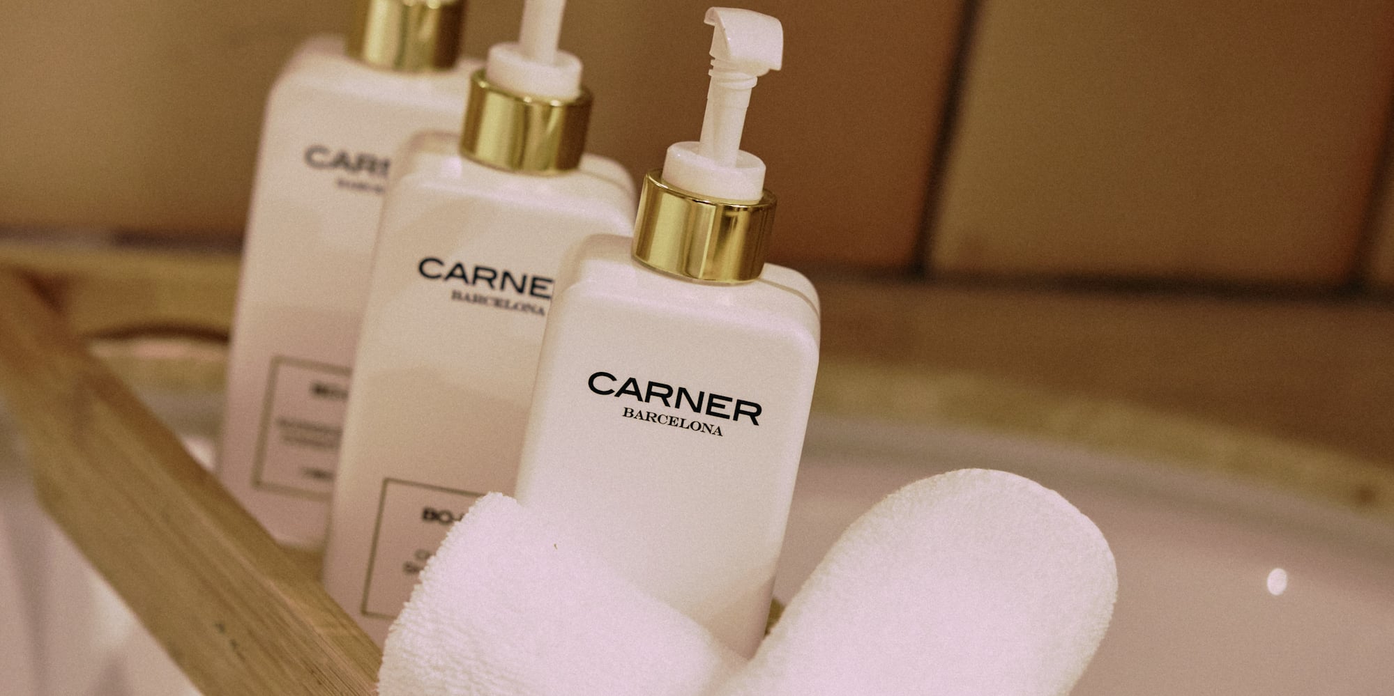 a group of white bottles and towels on a wooden shelf