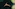 Aerial view of man floating peacefully in dark, clear natural water.
