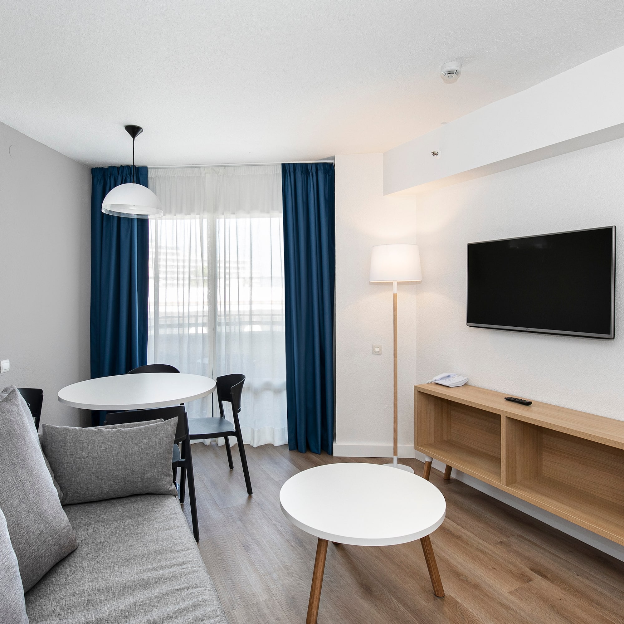 a room with a couch and table and tv