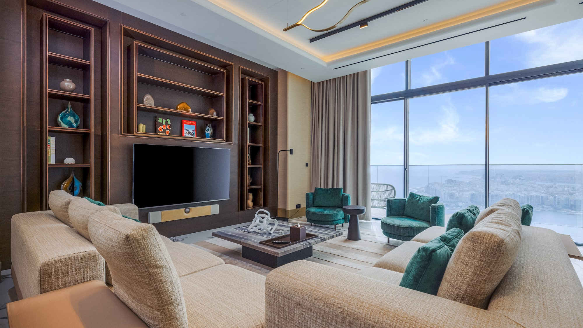 Modern living room with sofa, media center, and panoramic city view windows.