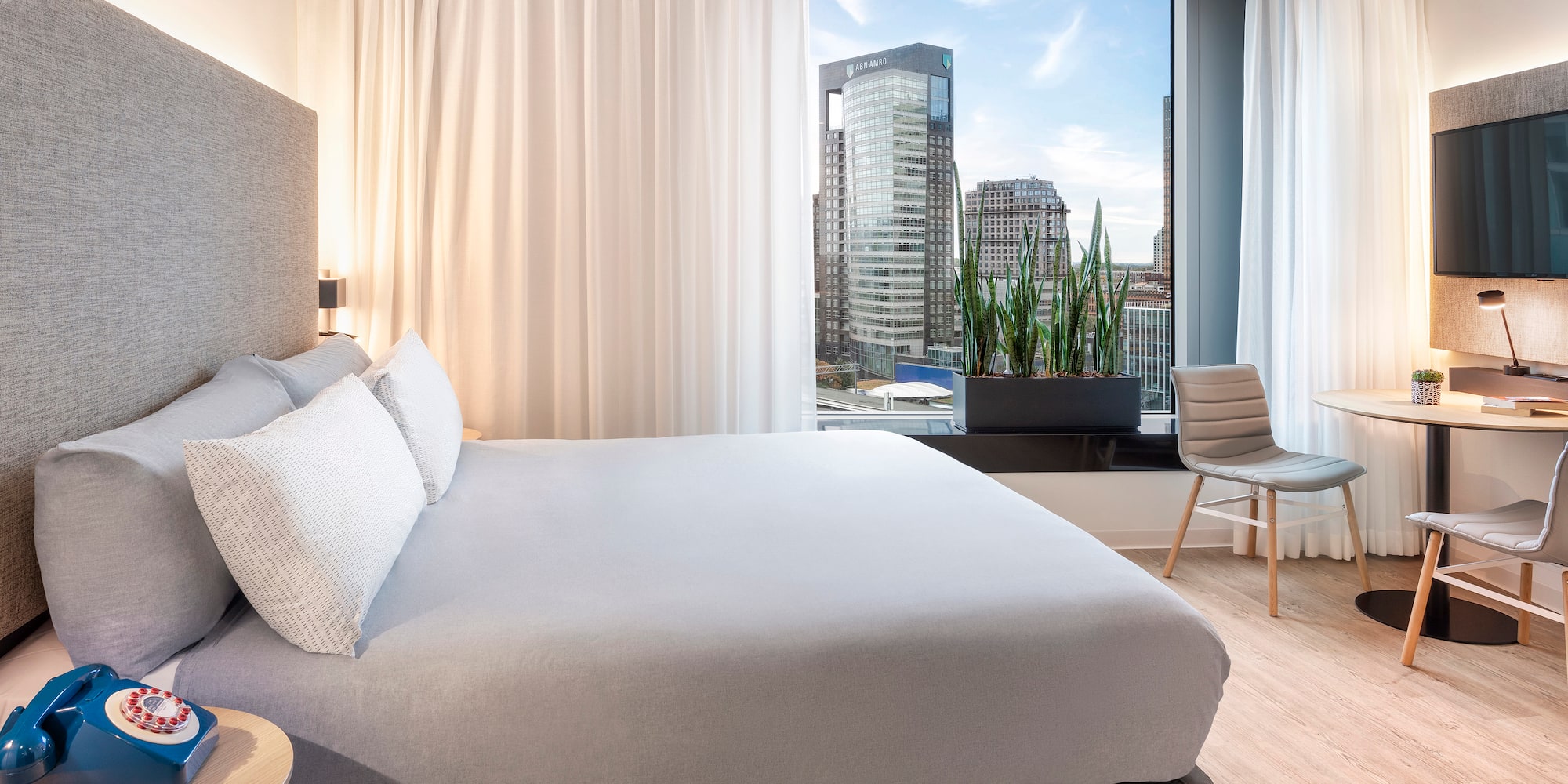 a bedroom with a large window and a bed