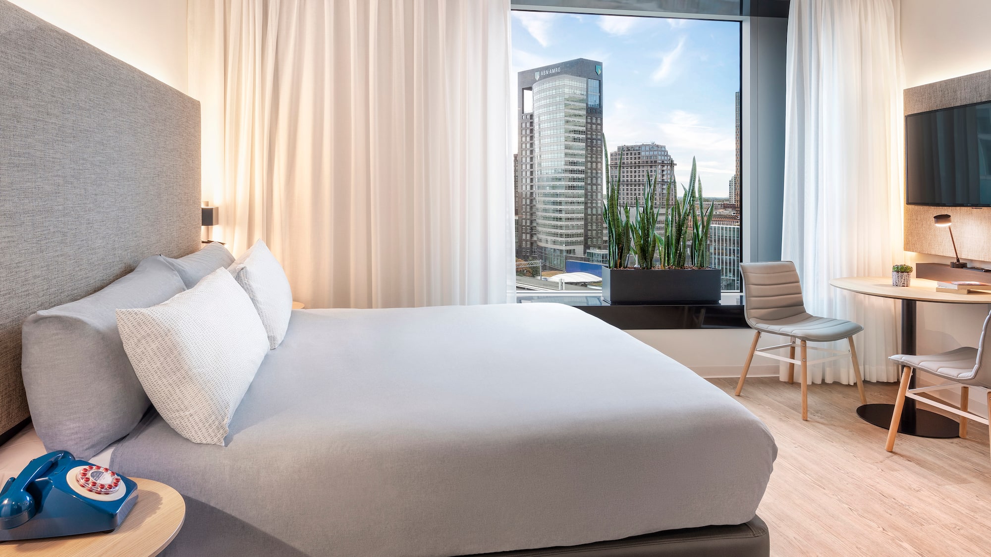 a bedroom with a large window and a bed