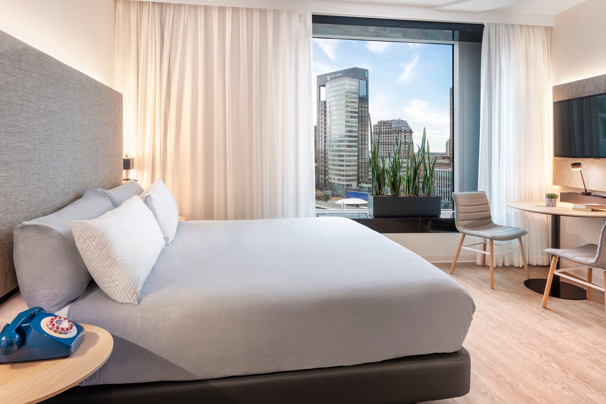 a bedroom with a large window and a bed