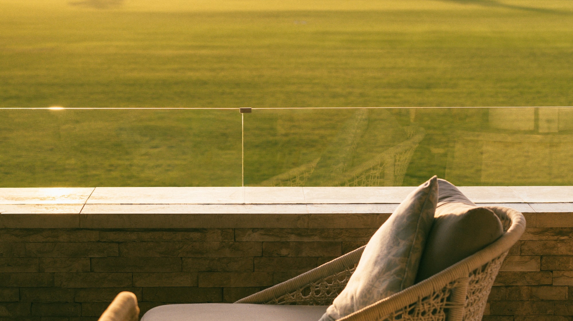 a chair on a balcony overlooking a golf course
