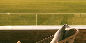 a chair on a balcony overlooking a golf course