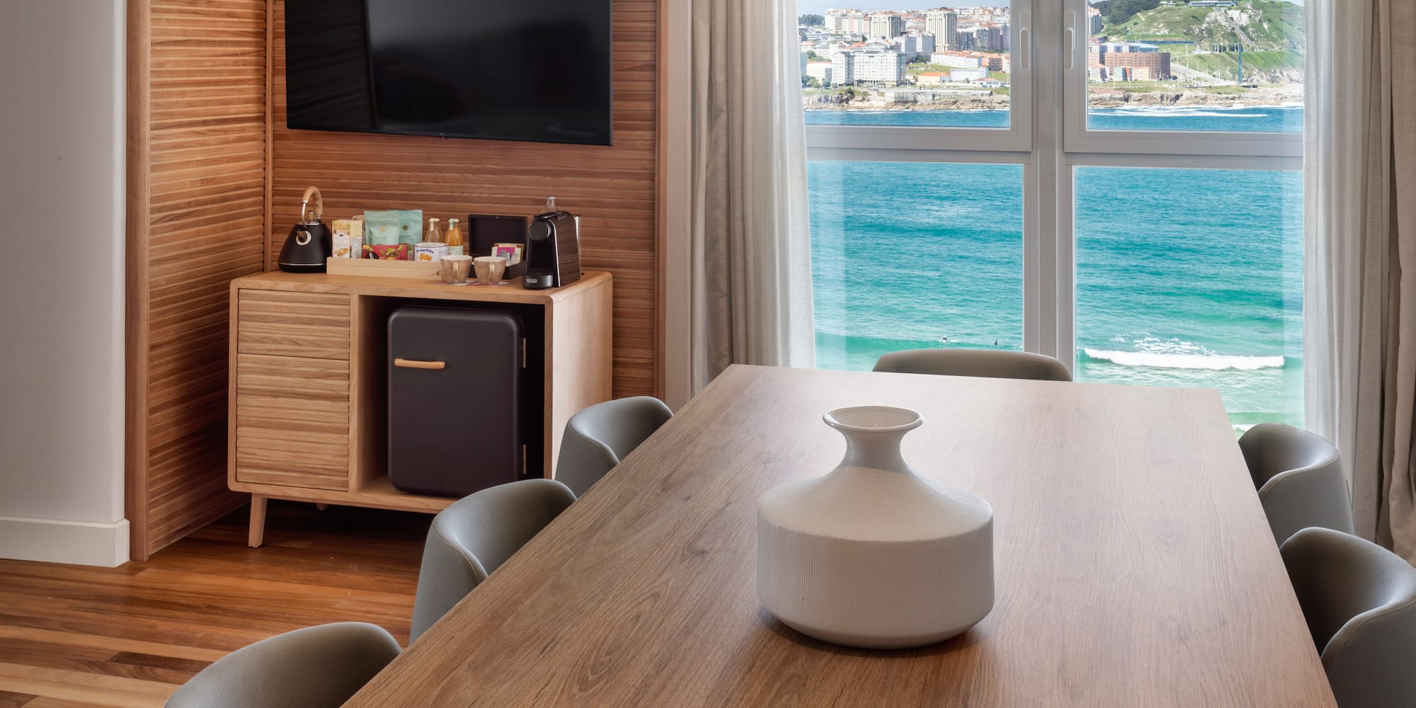 a room with a table and chairs and a television