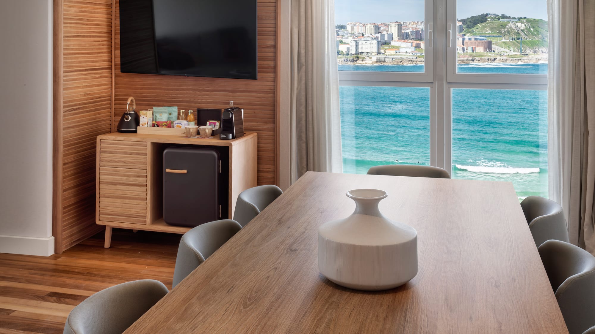 a room with a table and chairs and a television