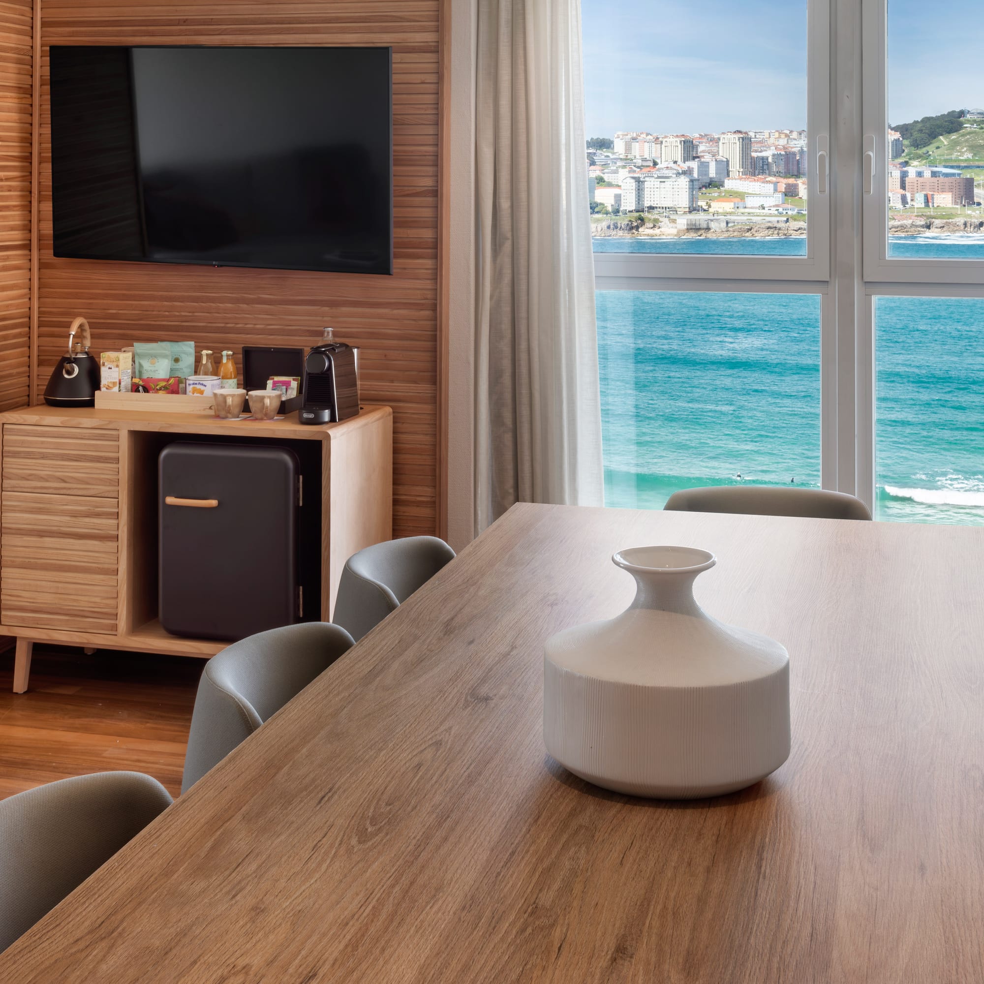 a room with a table and chairs and a television