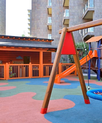a playground with a swing and slide