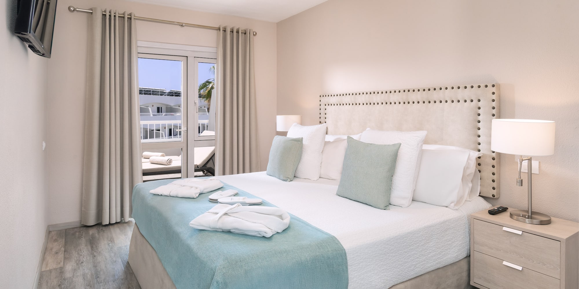 a bed with white and blue bedding