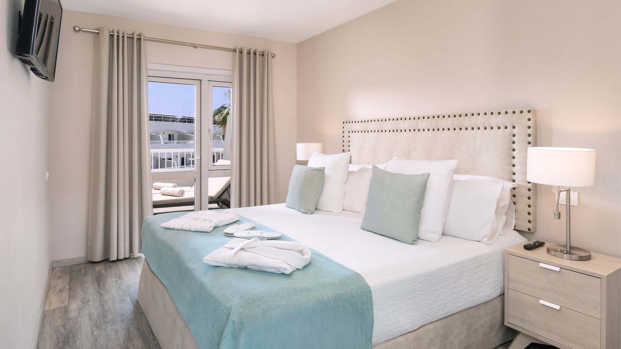 a bed with white and blue bedding