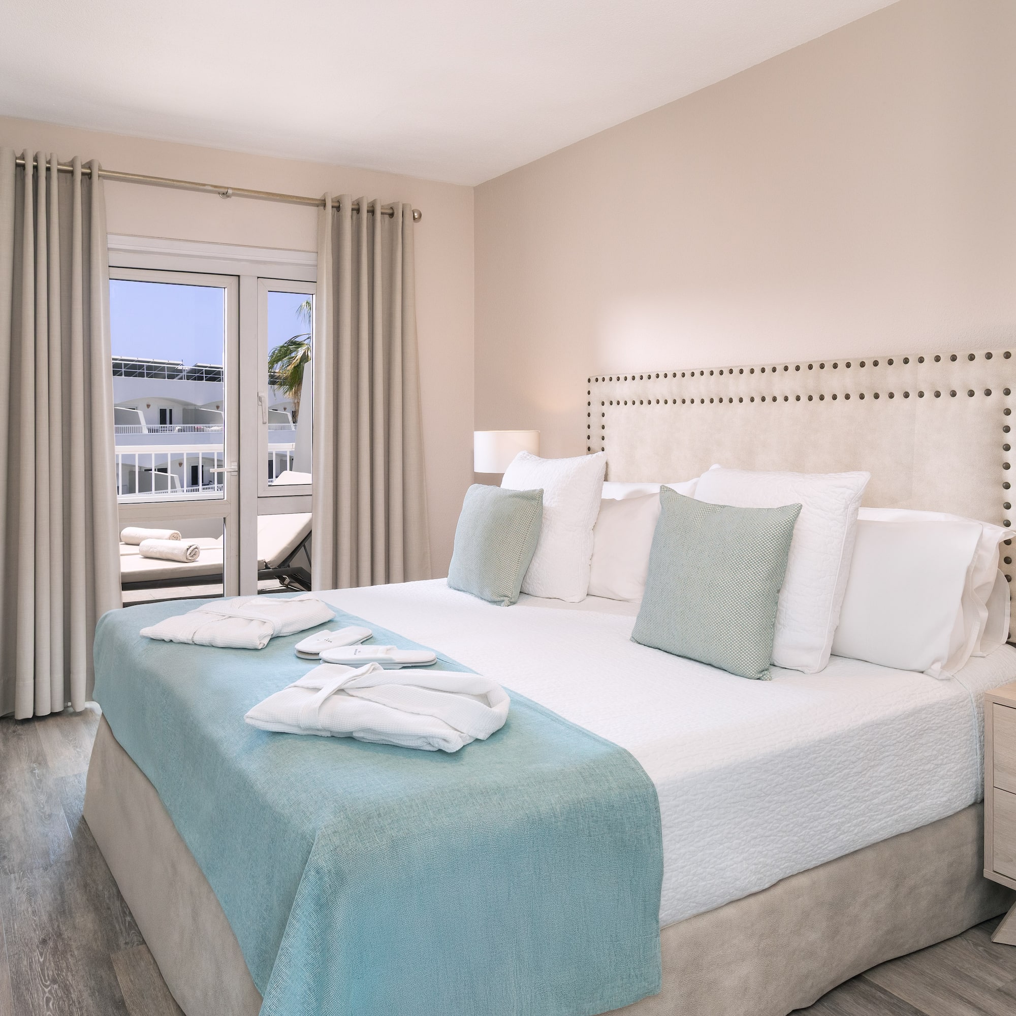 a bed with white and blue bedding