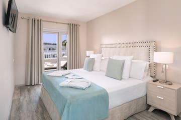 a bed with white and blue bedding