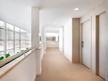 a hallway with a door and railing