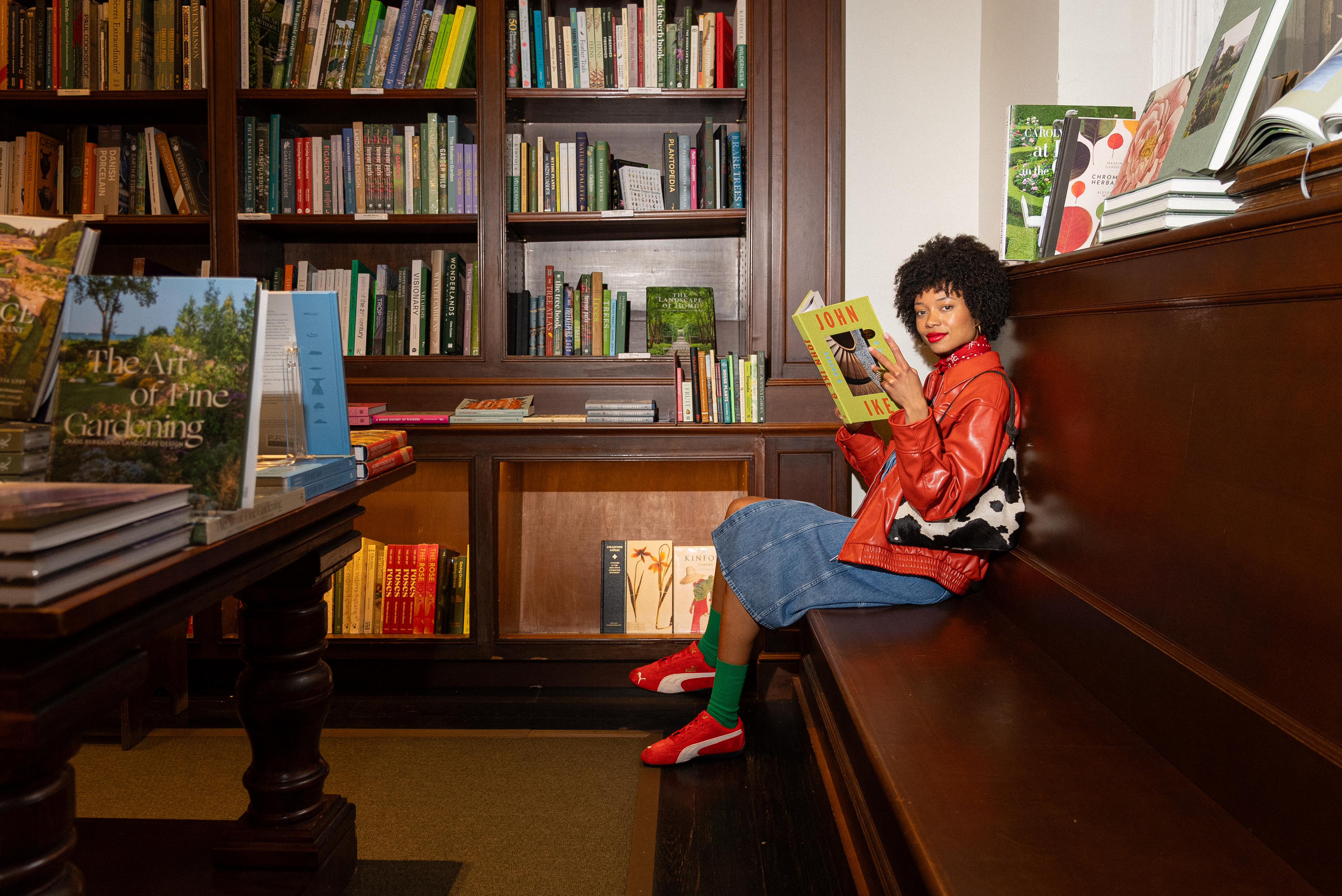 a woman sitting on a bench reading a book
