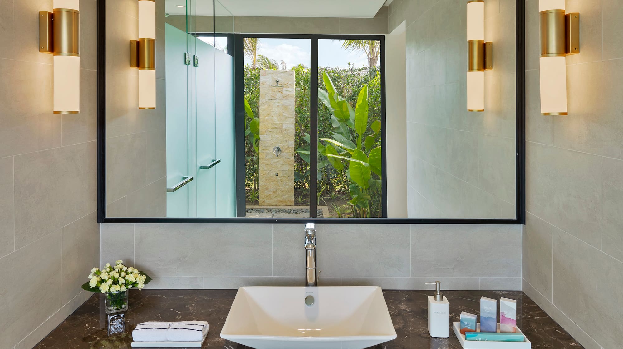 a bathroom with a mirror and sink