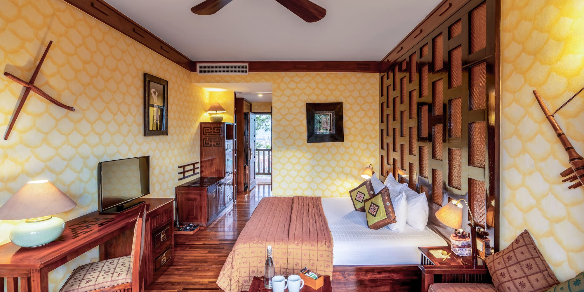 a room with a bed and a television