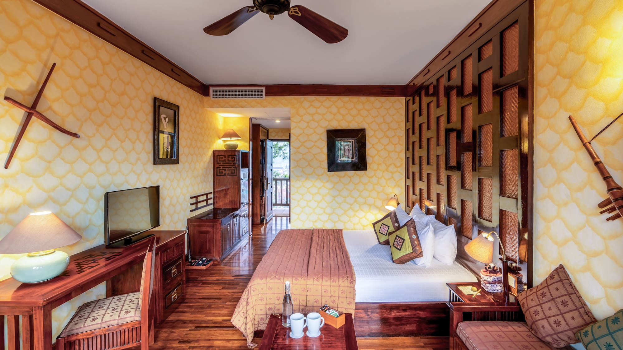 a room with a bed and a television