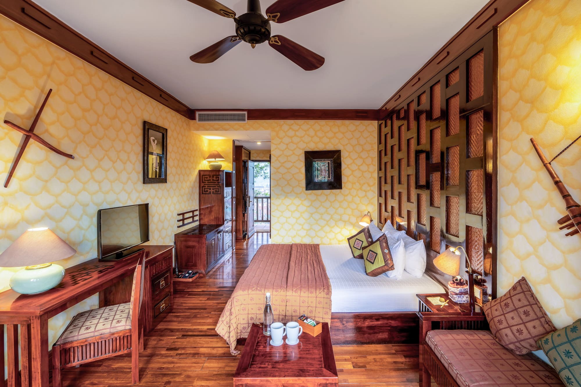 a room with a bed and a television