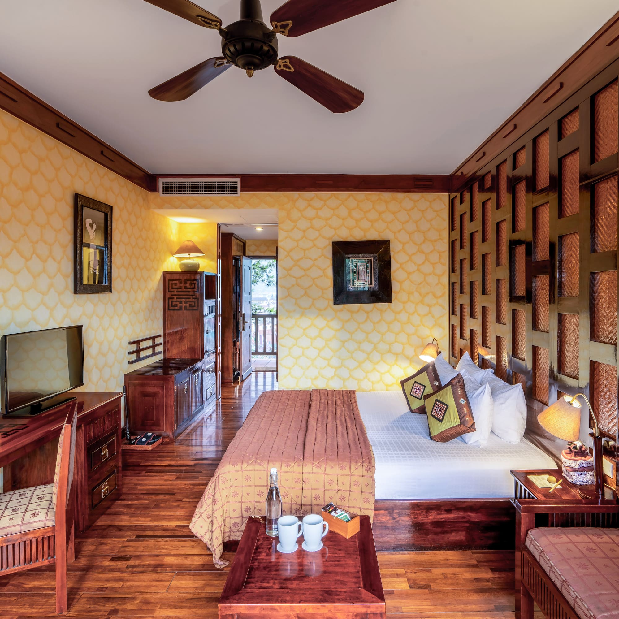 a room with a bed and a television