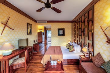 a room with a bed and a television