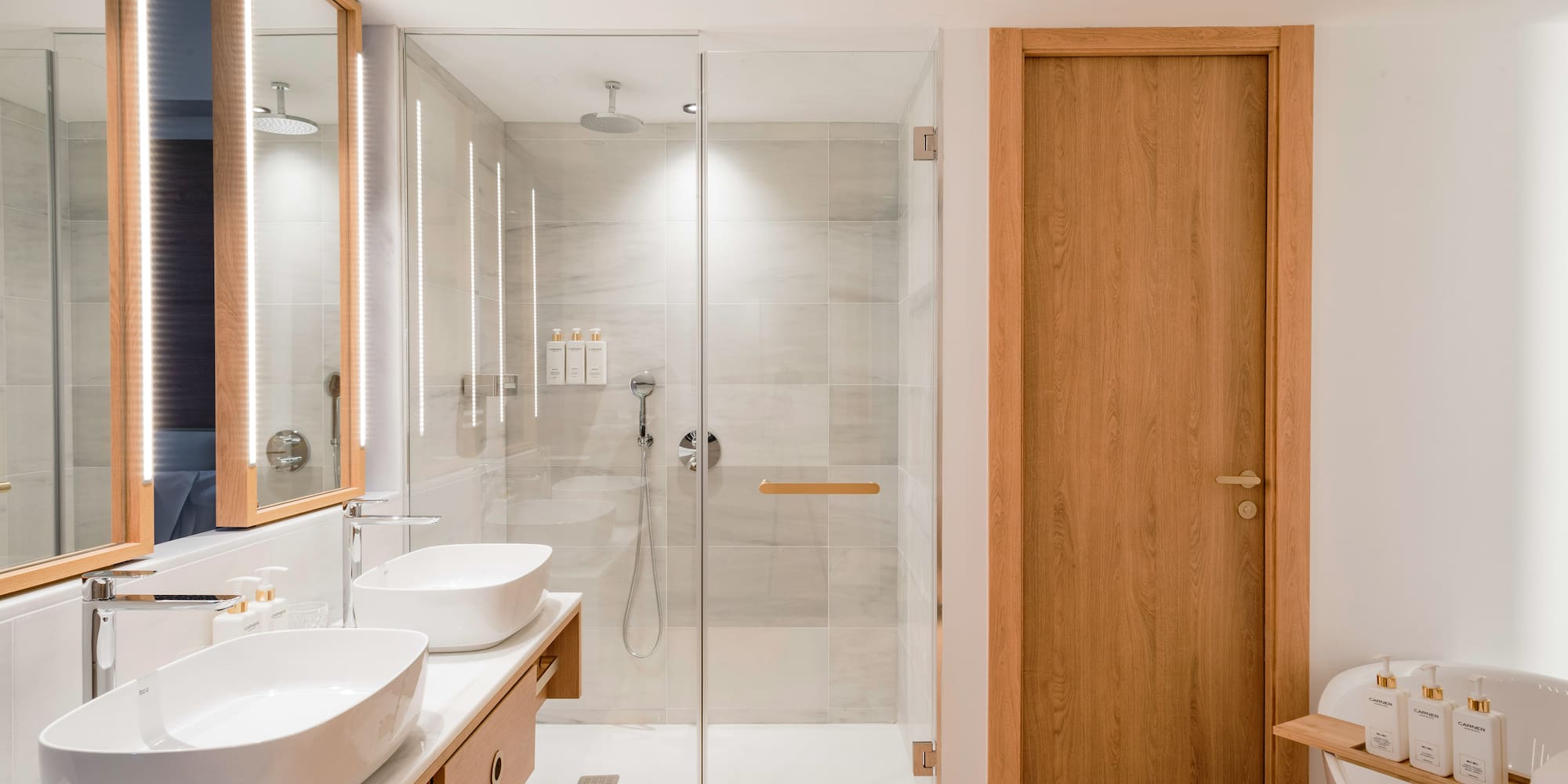 a bathroom with a glass shower and sink