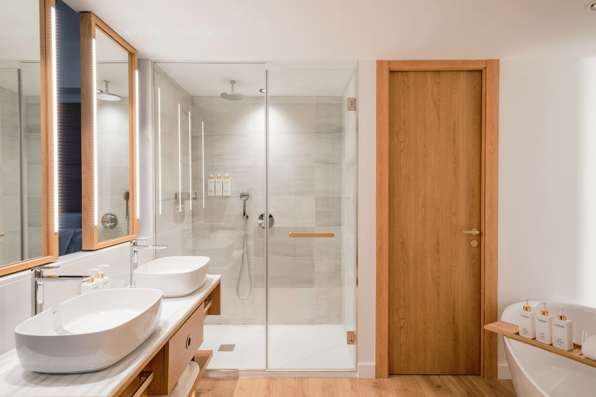 a bathroom with a glass shower and sink