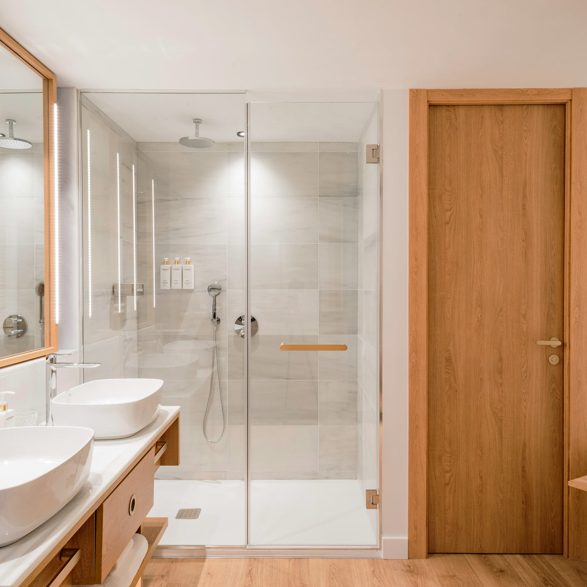a bathroom with a glass shower and sink