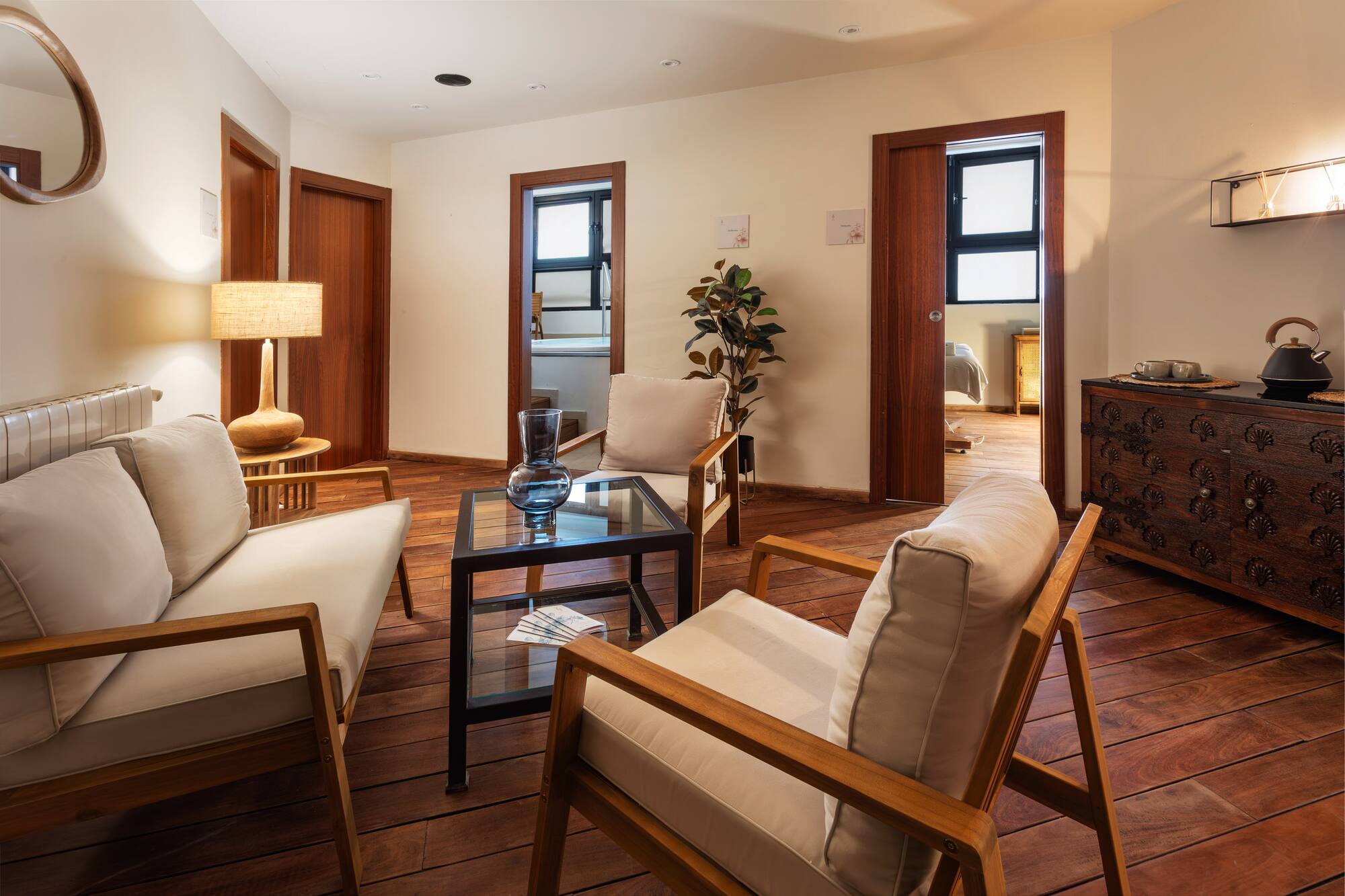 a room with white furniture and a wood floor
