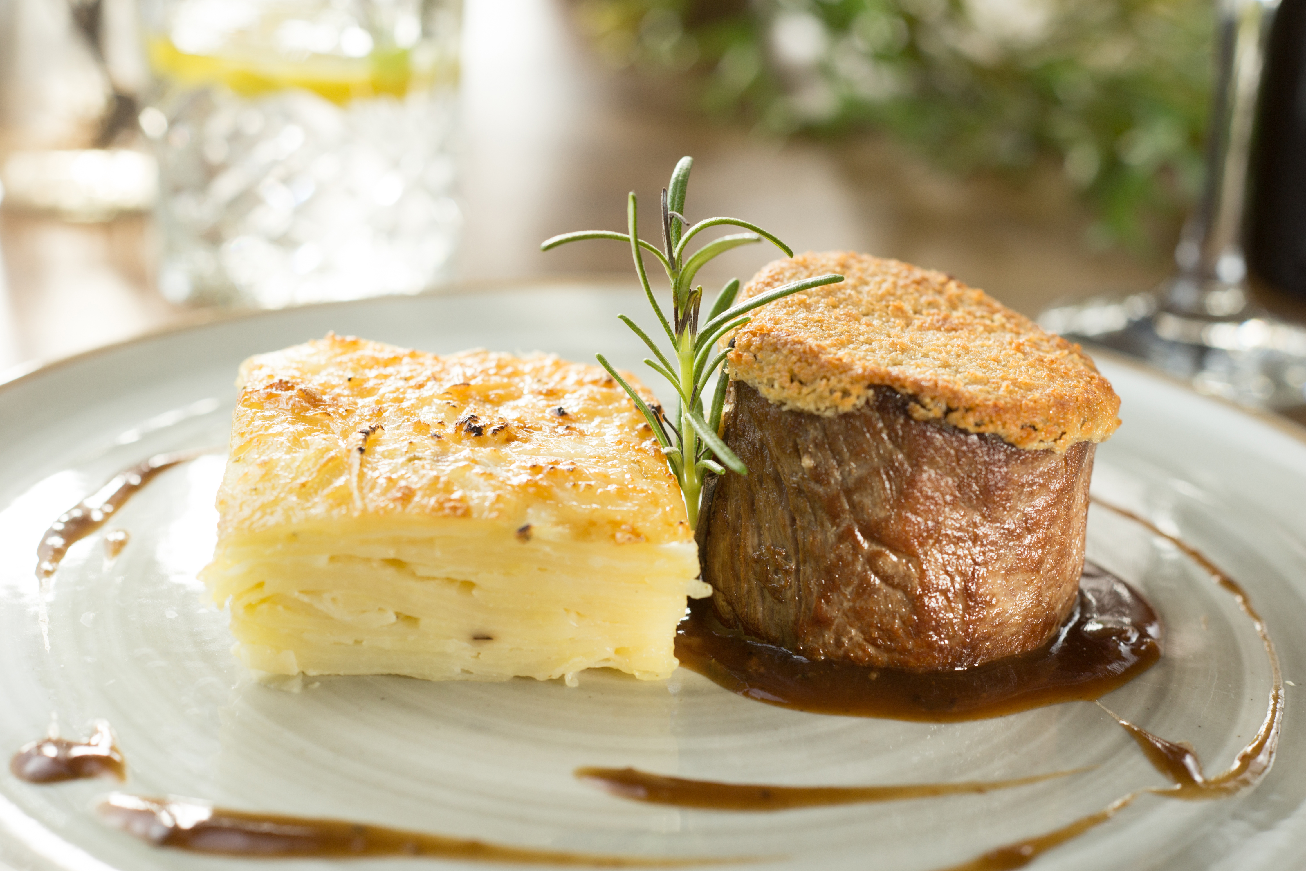 Fine dining beef medallion with crispy crust, potato gratin, and fresh rosemary.