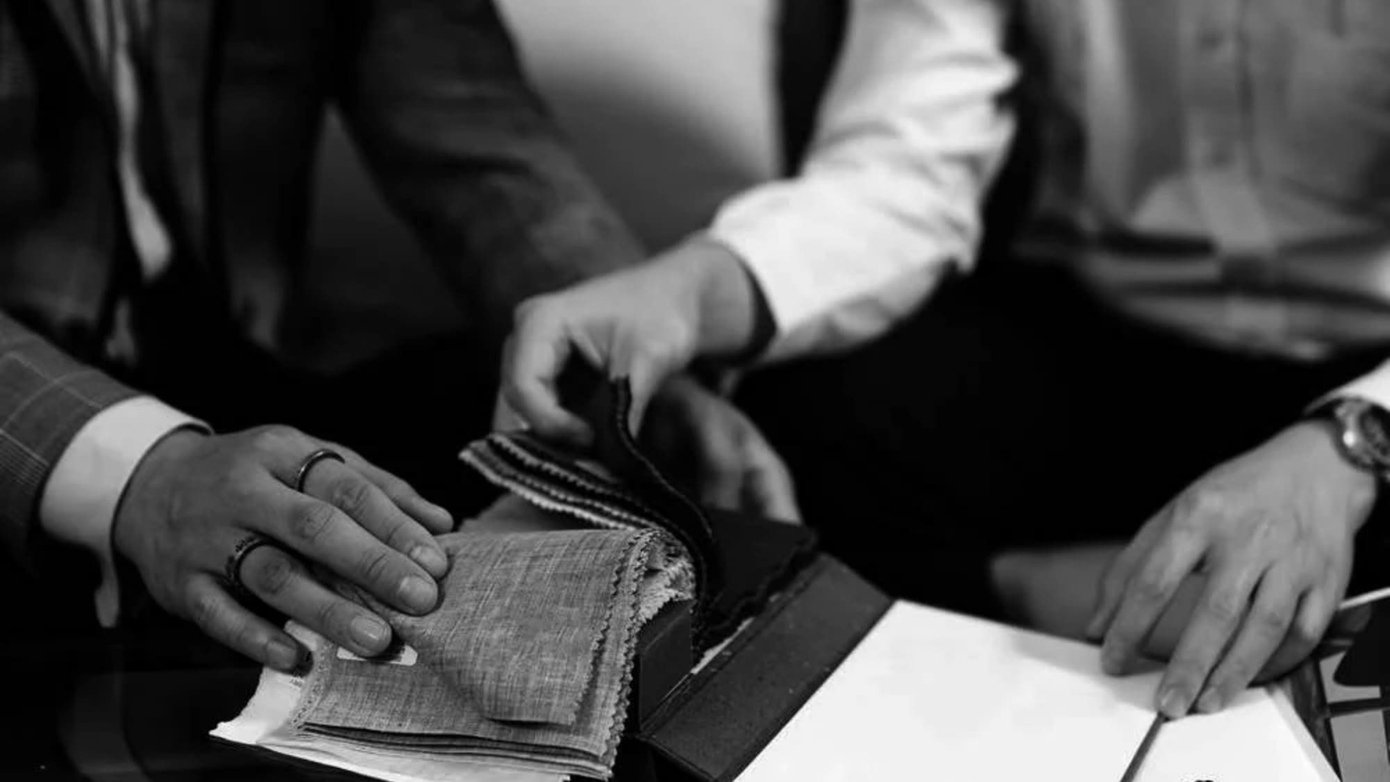 a pair of people looking at fabric samples