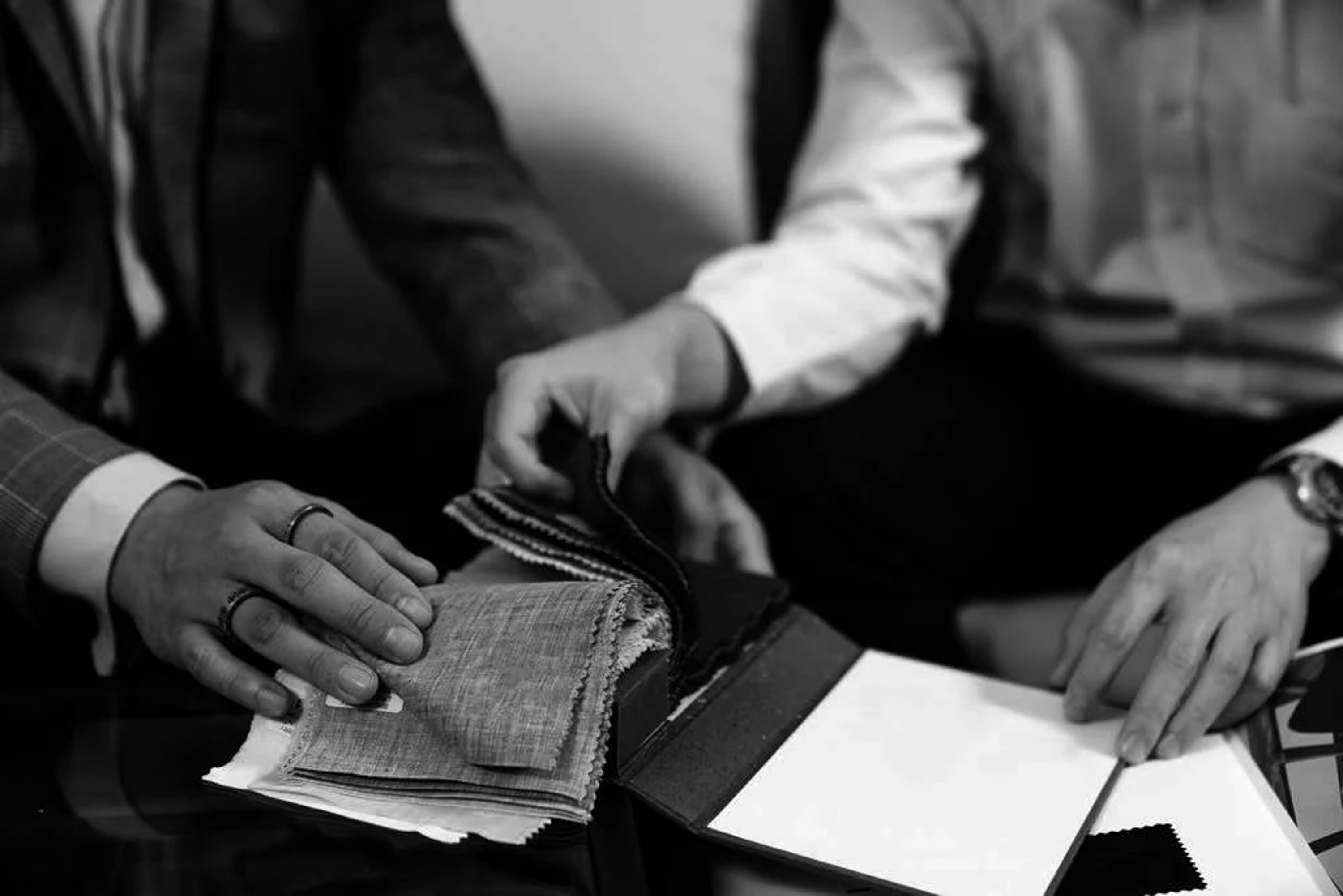 a pair of people looking at fabric samples