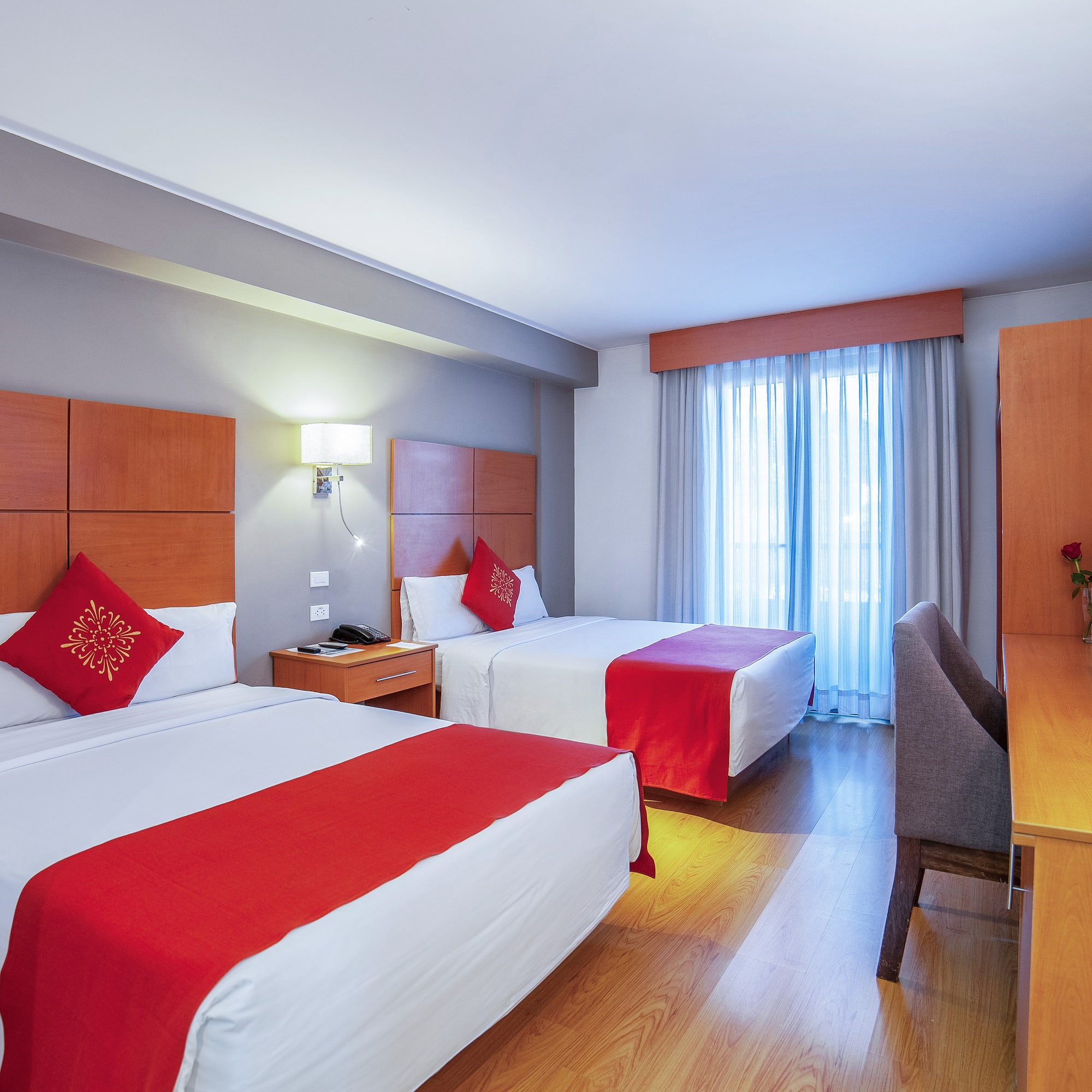 a room with two beds and a desk