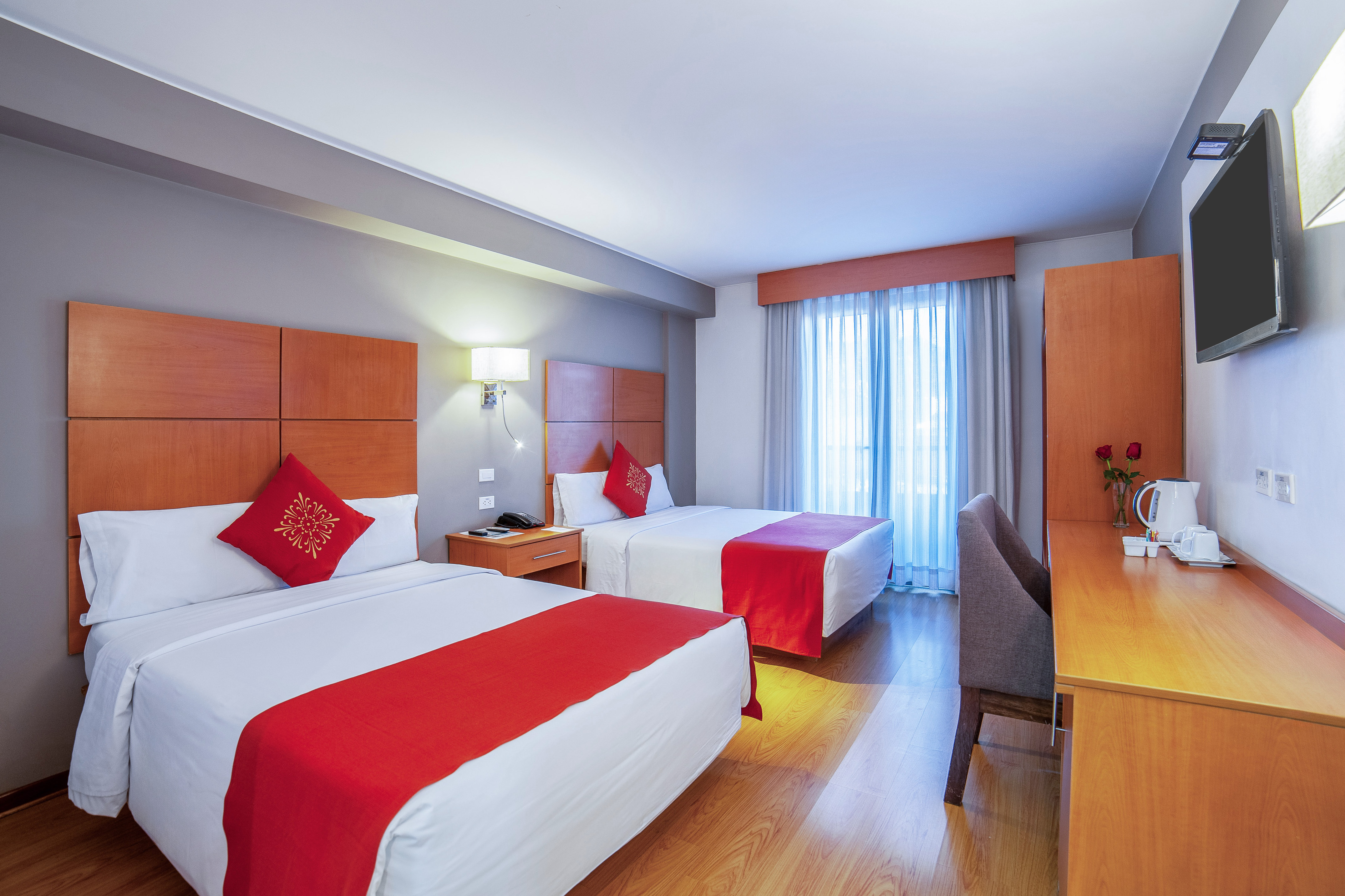 a room with two beds and a desk