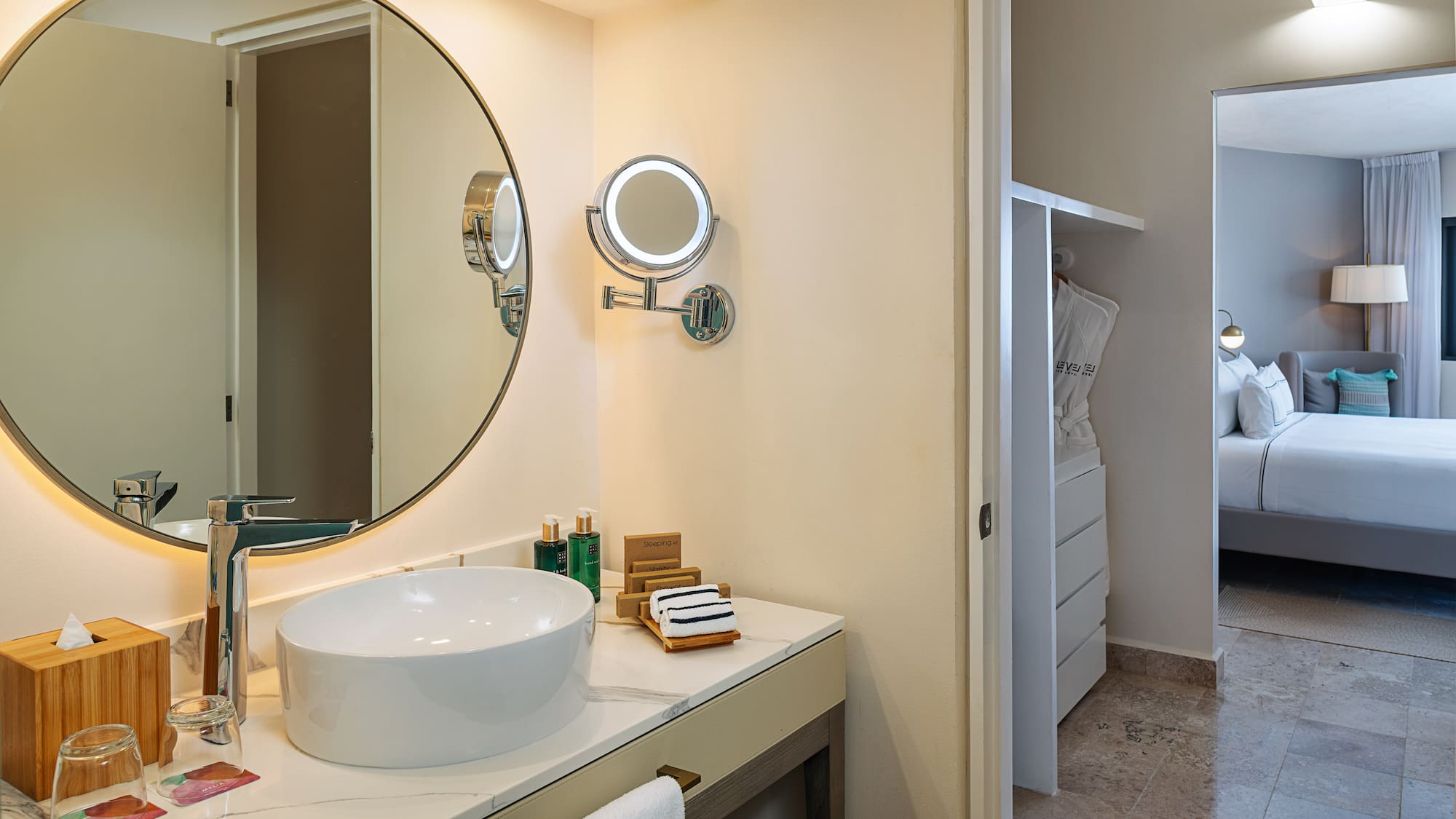 a bathroom with a round mirror and a sink