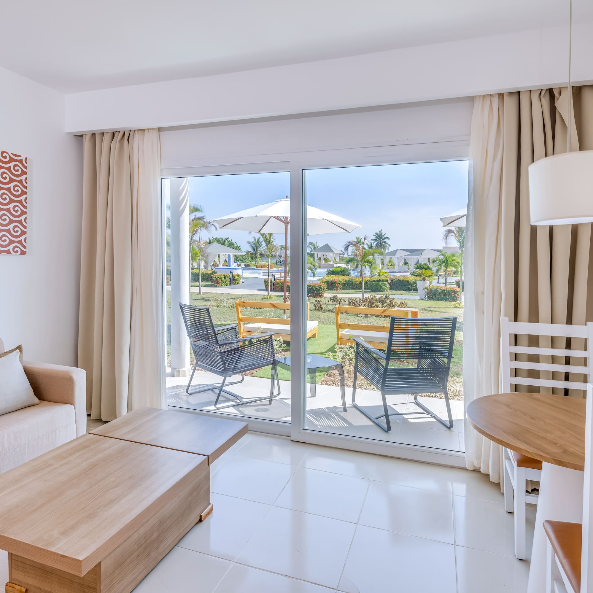 a room with a sliding glass door and chairs