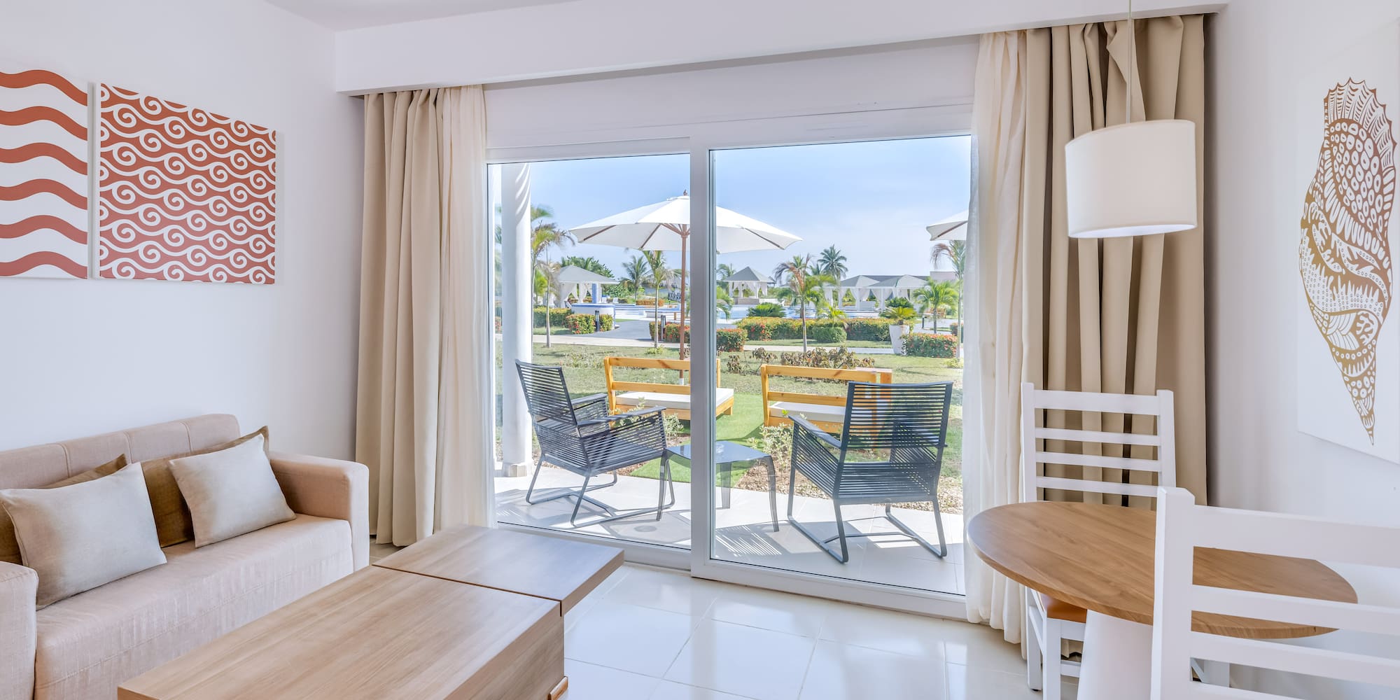 a room with a sliding glass door and chairs