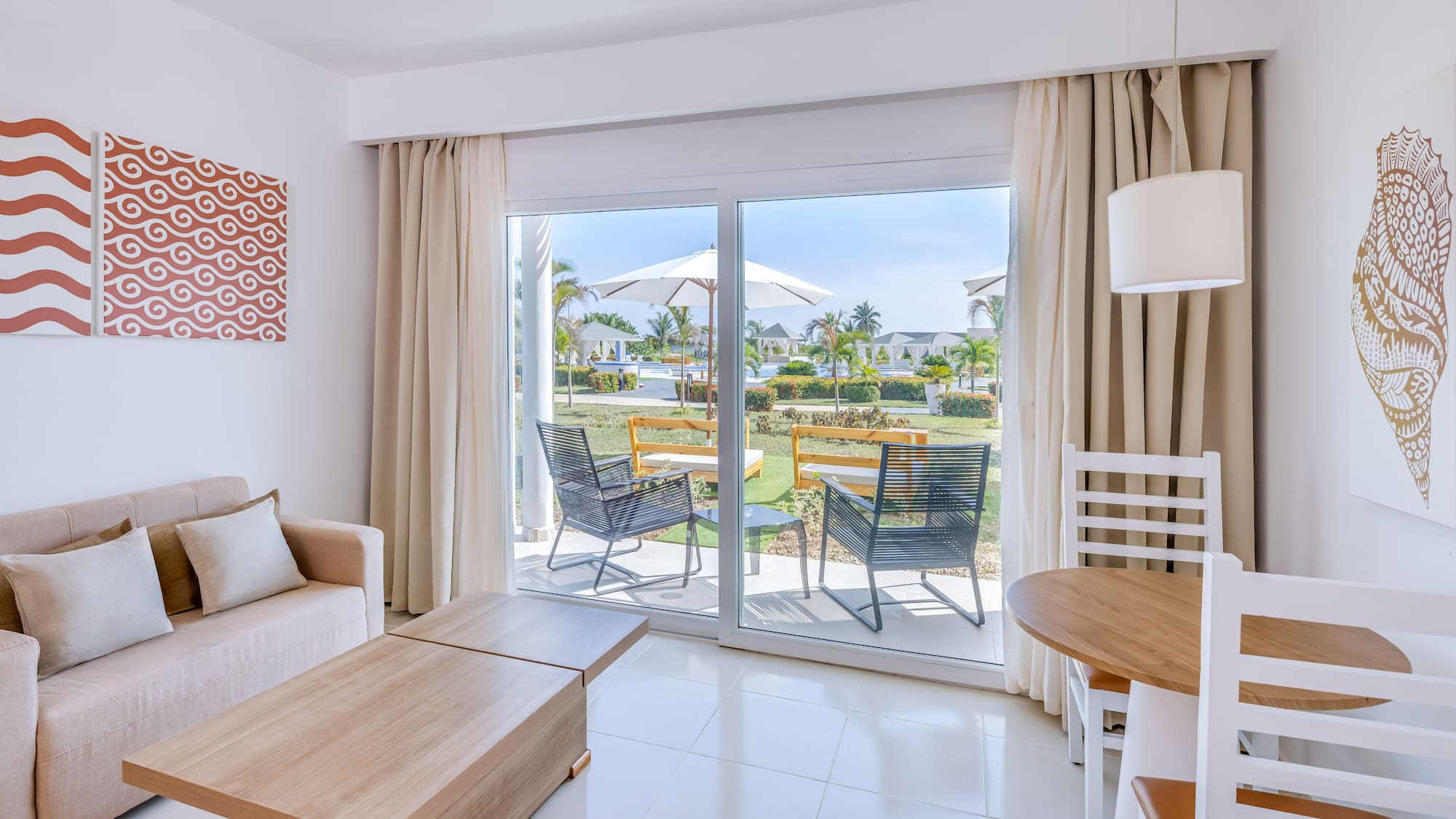 a room with a sliding glass door and chairs
